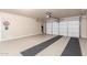 Clean and organized garage with epoxy flooring and an automatic door, perfect for car storage at 13102 S 177Th Dr, Goodyear, AZ 85338