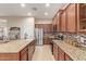 Open kitchen featuring an island with sink, stainless steel appliances, and granite countertops at 13102 S 177Th Dr, Goodyear, AZ 85338