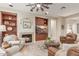 Cozy living room with a fireplace, built-in shelving, and comfortable seating near entertainment center at 13102 S 177Th Dr, Goodyear, AZ 85338