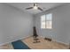 Neutral bedroom featuring a ceiling fan, large window and space for gym equipment at 13341 W Yearling Rd, Peoria, AZ 85383