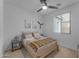 Neutral bedroom featuring a ceiling fan, window and decor at 13341 W Yearling Rd, Peoria, AZ 85383