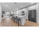 Modern kitchen with white cabinets, an island with seating, and stainless steel appliances at 13341 W Yearling Rd, Peoria, AZ 85383