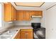 Kitchen features wood cabinets and black appliances at 15402 N 28Th St # 201, Phoenix, AZ 85032