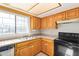 Kitchen features wood cabinets and black appliances at 15402 N 28Th St # 201, Phoenix, AZ 85032