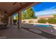 Covered patio with a stone waterfall feature flowing into a pool at 15788 W Sierra St, Surprise, AZ 85379