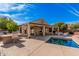 Relaxing backyard oasis with a pool, built in grill and covered patio for entertaining guests at 15788 W Sierra St, Surprise, AZ 85379