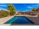 Backyard featuring a sparkling pool and desert landscaping, creating a serene retreat at 15788 W Sierra St, Surprise, AZ 85379