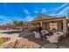 Inviting backyard featuring a covered patio, pool, fire pit, and outdoor seating area perfect for entertaining at 15788 W Sierra St, Surprise, AZ 85379