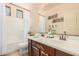 Bathroom with double sink vanity, large mirror, and tub at 15788 W Sierra St, Surprise, AZ 85379