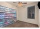 Carpeted bedroom with plastic storage containers lining one wall at 15788 W Sierra St, Surprise, AZ 85379