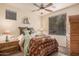 Cozy bedroom featuring a ceiling fan, window, and southwestern-style bedding at 15788 W Sierra St, Surprise, AZ 85379