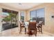 Bright dining area featuring tile floors, a sliding glass door, and ample natural light for enjoyable meals at 15788 W Sierra St, Surprise, AZ 85379