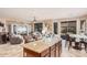 Bright kitchen featuring an island, dark wood cabinetry, stainless steel appliances, and an open floor plan at 15788 W Sierra St, Surprise, AZ 85379