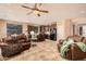 Open-concept living area featuring tile floors, bar stool seating at island, and a seamless flow to kitchen at 15788 W Sierra St, Surprise, AZ 85379