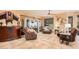 Cozy living room featuring tile floors, comfortable seating, a ceiling fan, and abundant natural light at 15788 W Sierra St, Surprise, AZ 85379