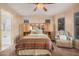 Comfortable main bedroom features a ceiling fan, a seating area, and neutral décor at 15788 W Sierra St, Surprise, AZ 85379