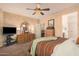 Comfortable main bedroom features a ceiling fan, a dresser, and neutral décor at 15788 W Sierra St, Surprise, AZ 85379