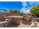 Backyard with a complete outdoor kitchen perfect for entertaining and enjoying outdoor meals at 15788 W Sierra St, Surprise, AZ 85379