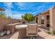 Outdoor kitchen and dining area create a perfect space for entertaining in the backyard at 15788 W Sierra St, Surprise, AZ 85379