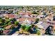 Aerial view of homes in a neighborhood, surrounded by lush greenery and mature trees at 16161 W Monte Cristo Ave, Surprise, AZ 85374