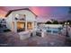 Outdoor kitchen and patio area with built-in grill, bar, and sink, perfect for outdoor dining at 16161 W Monte Cristo Ave, Surprise, AZ 85374