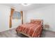 Bedroom featuring a warm colored comforter, a window, and hardwood flooring at 16161 W Monte Cristo Ave, Surprise, AZ 85374