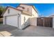 Side view of a two car garage with tile roof and a wooden gate to the backyard at 16161 W Monte Cristo Ave, Surprise, AZ 85374