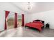 Main bedroom with a red comforter, an area to walk out onto a balcony, and modern lighting at 16161 W Monte Cristo Ave, Surprise, AZ 85374