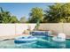 Backyard pool featuring a waterfall feature and inflatable floats, creating a relaxing outdoor oasis at 16161 W Monte Cristo Ave, Surprise, AZ 85374