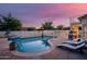 Backyard pool with lounge chairs and privacy fence at 16161 W Monte Cristo Ave, Surprise, AZ 85374