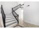 Staircase featuring white stairs and black bannisters at 16161 W Monte Cristo Ave, Surprise, AZ 85374