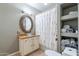 Elegant bathroom vanity with a glass bowl sink and patterned shower curtain at 16734 E La Montana Dr # 103, Fountain Hills, AZ 85268