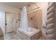 Bathroom with a tile-surround tub and textured shower column at 16734 E La Montana Dr # 103, Fountain Hills, AZ 85268