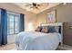 Bedroom with guitar-themed pillows, ceiling fan, and natural light at 16734 E La Montana Dr # 103, Fountain Hills, AZ 85268