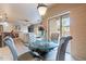 Dining area with a glass table, upholstered chairs, and sliding glass doors at 16734 E La Montana Dr # 103, Fountain Hills, AZ 85268