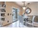 Dining room with a glass table, upholstered chairs, and sliding glass doors to the pool at 16734 E La Montana Dr # 103, Fountain Hills, AZ 85268