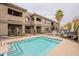 Beautiful pool area surrounded by desert landscaping and outdoor seating for relaxing by the water at 16734 E La Montana Dr # 103, Fountain Hills, AZ 85268