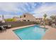 Community swimming pool surrounded by desert landscaping and townhomes at 16734 E La Montana Dr # 103, Fountain Hills, AZ 85268