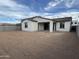 Home exterior displays ample backyard with white stucco and covered patio at 18032 W Vogel Ave, Goodyear, AZ 85338