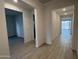 Bright hallway featuring light tile flooring and neutral walls leading to various rooms at 18032 W Vogel Ave, Goodyear, AZ 85338