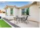 Inviting back patio featuring outdoor dining set and string lights, perfect for alfresco meals and evening gatherings at 18248 W Carlota Ln, Surprise, AZ 85387