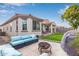 A cozy backyard patio with desert landscaping, artificial grass, and an outdoor seating area at 18248 W Carlota Ln, Surprise, AZ 85387