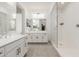 This bathroom features a glass shower, tile flooring, double sink with a large vanity at 18248 W Carlota Ln, Surprise, AZ 85387