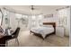 Cozy bedroom with light-filled windows, ceiling fan, and neutral color scheme at 18248 W Carlota Ln, Surprise, AZ 85387