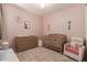 A delightful Bedroom features a wooden crib, matching dresser, and cozy rocking chair, creating a sweet, serene space at 18248 W Carlota Ln, Surprise, AZ 85387