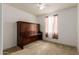 This inviting bedroom showcases a space-saving Murphy bed, a ceiling fan, and soft natural light from a window at 18248 W Carlota Ln, Surprise, AZ 85387