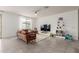 Bright living room featuring tile floors, a ceiling fan, and a large window at 18248 W Carlota Ln, Surprise, AZ 85387