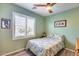 Cozy bedroom with a comfortable bed, shuttered window, and green painted walls at 20194 N Riverbank Rd, Maricopa, AZ 85138