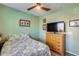 A cozy bedroom with a ceiling fan and hardwood floors at 20194 N Riverbank Rd, Maricopa, AZ 85138