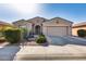 Charming single-story home featuring desert landscaping, a two-car garage, and covered front entry at 20194 N Riverbank Rd, Maricopa, AZ 85138